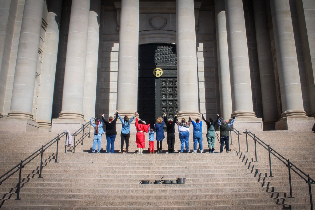 a group of Organizing Okies standing on steps leading to the Oklahoma State Capital Building